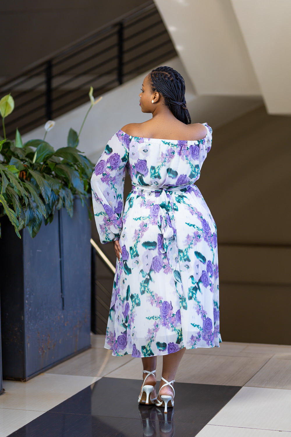 Lilac off shoulder dress with floral pattern.